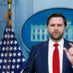 VP Vance Targets Democrats in Fiery Speech Man speaking at podium with US flag behind