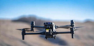 Drone flying in a clear blue sky