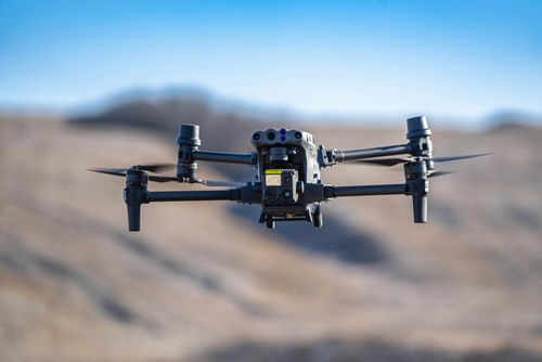 Drone flying in a clear blue sky