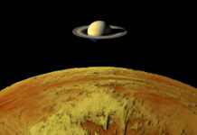 NASA’s Cassini Uncovers Saturn’s Violent Past Saturn above a yellow surface in space scene