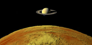 Saturn above a yellow surface in space scene