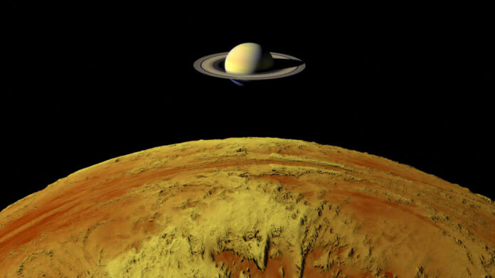 saturns-moon-titan1849101370jpg Saturn above a yellow surface in space scene