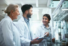 Evolution Revolution – Sponges Were First! Three scientists discussing work at a glass board