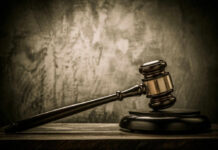 Judges gavel on a dark wooden surface.