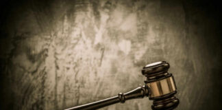 Judges gavel on a dark wooden surface.