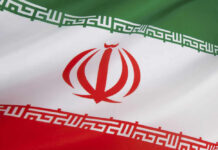 Iran’s Nuclear Mystery Deepens — War Looms? Iranian flag with green, white, red stripes.