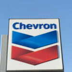 Chevron’s LNG Nightmare: War, Weather, and Chaos Chevron logo sign against blue sky