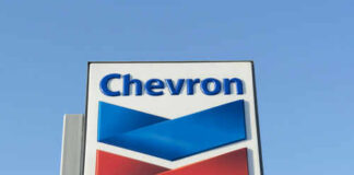 Chevron logo sign against blue sky
