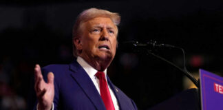 Man speaking at a podium with microphone