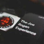 Rogan’s Stinging Critique Ignites Voter ID Clash Phone screen displaying The Joe Rogan Experience logo.