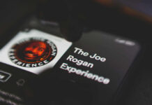 Phone screen displaying The Joe Rogan Experience logo.