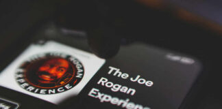 Phone screen displaying The Joe Rogan Experience logo.