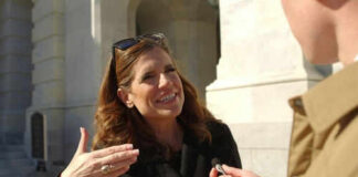 Woman speaking outside during an interview with microphone