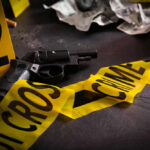 Staged Burglary Gone Wrong: Idol Star’s Dark Secret Gun surrounded by crime scene tape and evidence markers