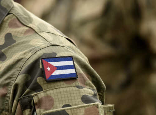 shutterstock_1527363221.jpg Close-up of a soldier's uniform featuring the Cuban flag patch