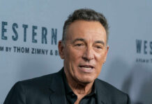 Close-up of a man in a black suit at a film premiere
