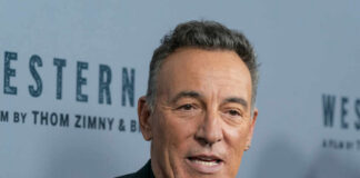 Close-up of a man in a black suit at a film premiere