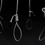 19-Year-Old Wrestler’s Execution Sparks Global Outcry Four nooses hanging against a dark background