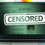 Online Safety Act Controversy—Freedom at Risk? A laptop screen displaying a 'CENSORED' label over blurred content