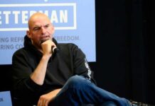 Person speaking into a microphone during an event