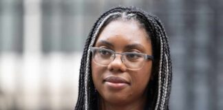 Close-up portrait of a woman with braided hair wearing glasses