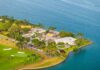 Aerial view of a coastal property with luxury homes and a golf course