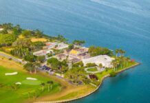 Aerial view of a coastal property with luxury homes and a golf course