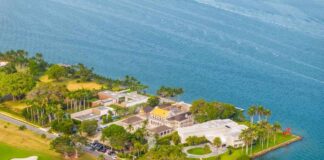 Aerial view of a coastal property with luxury homes and a golf course