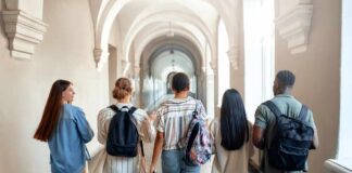 Group of students walking through a university corridor