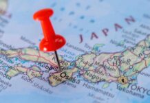 A close-up of a map of Japan with a red pushpin marking Osaka