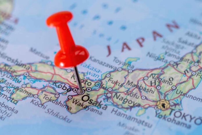 A close-up of a map of Japan with a red pushpin marking Osaka