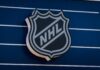 Devastating Blaze: NHL World Reeling from Loss NHL logo displayed on a blue background