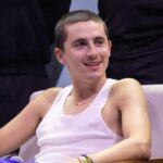 Chalamet’s Shocking Slam on Ballet & Opera A young man in a tank top smiling while seated in an interview setting