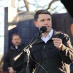Atheists More Christ-Like? Texas Dem Under Fire A speaker addressing an audience at an outdoor event with a microphone