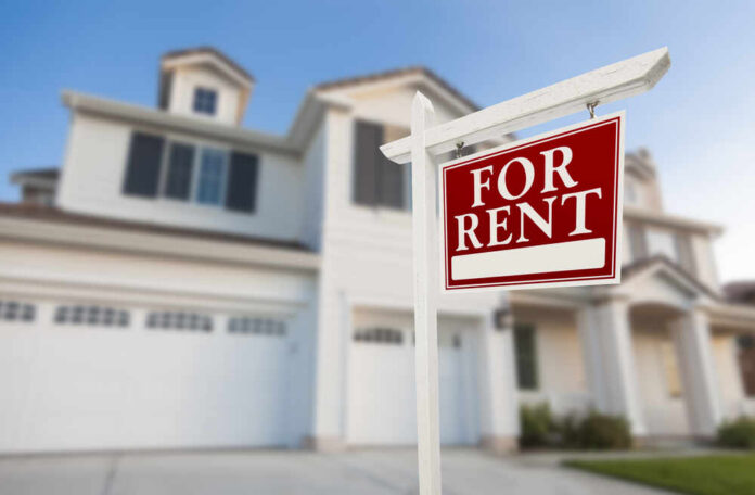 shutterstock_295804082.jpg A 'For Rent' sign in front of a house