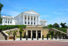 Historic government building with white columns and green lawn
