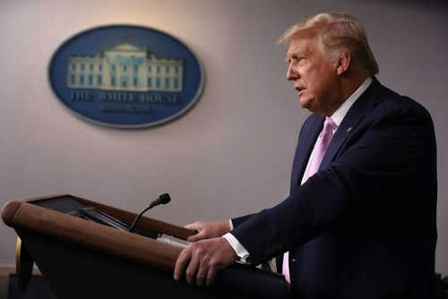 Person speaking at a podium with White House emblem