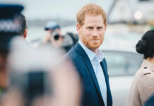A man in a suit smiling outdoors