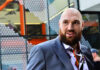 All-British Showdown: Fury vs Joshua BACK ON? Man with a beard wearing a colorful shirt and a suit in an urban environment