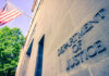 Exterior view of the Department of Justice building with an American flag