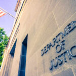 Exterior view of the Department of Justice building with an American flag