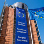Exterior view of the European Commission building with EU flags