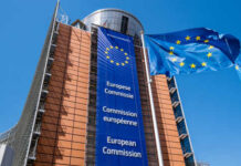 Exterior view of the European Commission building with EU flags