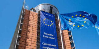 Exterior view of the European Commission building with EU flags