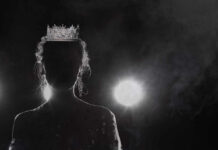 Silhouette of a person wearing a crown against a dark background with dramatic lighting