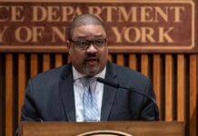A man speaking at a podium during a press conference