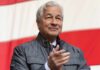 AI Lending: The Next Financial Time Bomb? A business leader applauding at an outdoor event with an American flag in the background
