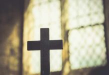 Biblical Ignorance on Display: Behar’s Bold Claim Silhouette of a wooden cross against a softly lit background