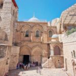 Historic religious site with tourists in an outdoor courtyard