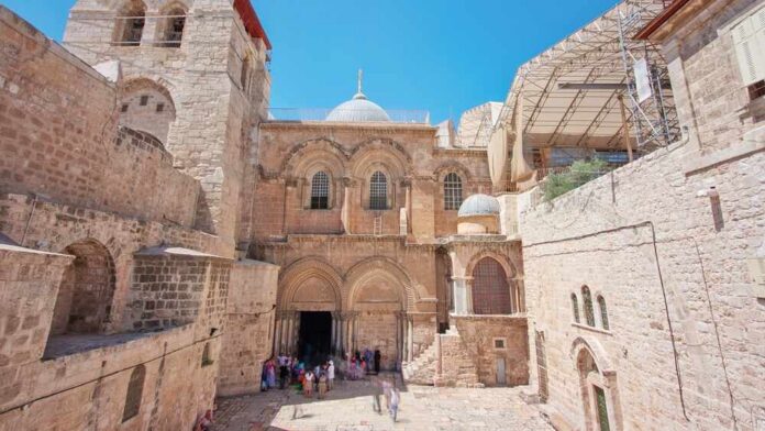 Historic religious site with tourists in an outdoor courtyard